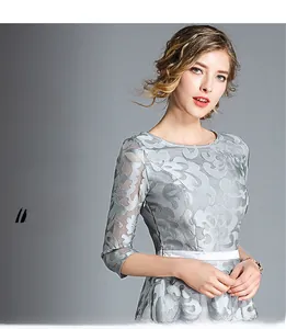 Detail of grey floral embroidery lace and sleek white waist belt on slim-fit dress