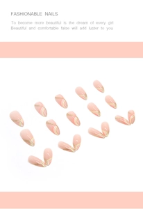 Macro detail of almond press-on nails with warm pink base and gold glitter stripe accents