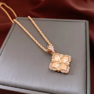 18K gold plated flower pendant necklace with diamonds on vintage velvet background
