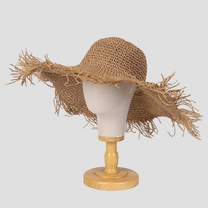 Handmade crochet straw sun hat with wide brim and fringe detail for summer beach