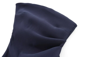 Detailed macro view of dark blue fabric texture showing subtle grain and smooth folds