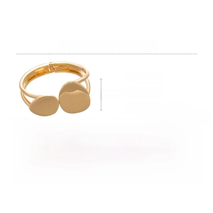 Macro detail of wide gold alloy cuff with irregular texture and size measurements