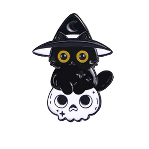 Close-up of Halloween black cat enamel pin with wizard hat and skull design