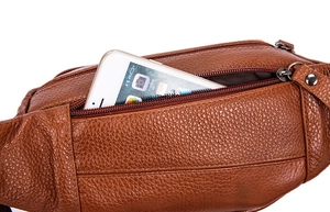 Macro shot of large capacity brown pebbled leather waist bag with zipper pocket and phone