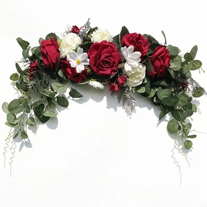 Close-up of artificial floral garland with red roses, white cosmos and eucalyptus