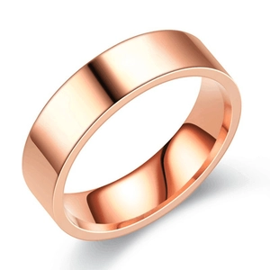 Close-up of polished rose gold titanium steel flat band ring with reflective finish