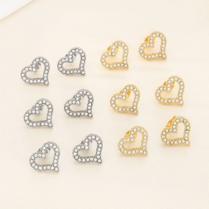 Luxe hollow heart-shaped stud earrings in gold and silver with crystal pavé stones