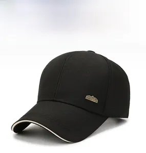 Detail of black cotton baseball cap with vintage bronze sports logo and cream sandwich brim