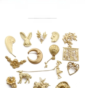 Macro view of vintage gold metal brooches collection with pearls and baroque texture