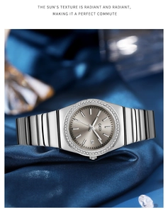 Detail of GEDI quartz watch with sunray dial and rhinestone bezel on blue silk satin