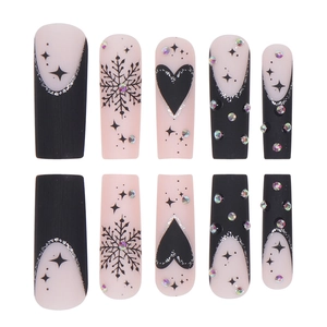 Faux ongles de Noël longs noir et rose avec motifs de flocons et strass brillants