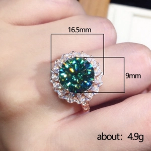 Rose gold ring with teal green zircon center stone and halo of white crystals for women