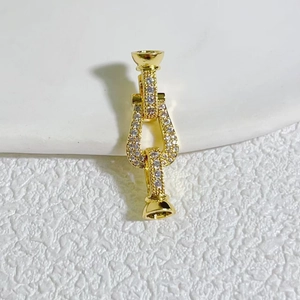 Macro detail of gold plated cherry pendant with micro-set zircon for DIY jewelry
