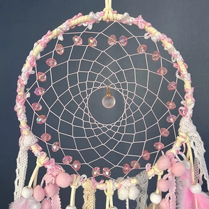 Handmade pink dream catcher with glass beads and feathers for wall hanging decor
