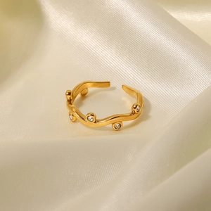 18K gold wave open ring with delicate diamond leaf patterns on gold silk fabric