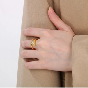 Detail view of a 18k gold-plated stainless steel snake ring with a small diamond accent