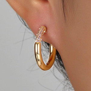 Close-up of S925 sterling silver gold hoop earrings with pavé set purple cubic zirconia