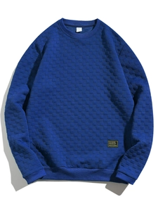Detail of navy blue slim fit sweatshirt showing textured checkerboard knit fabric