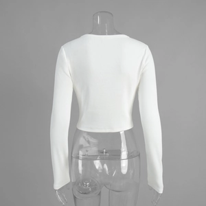 Back view of a white ribbed knit cropped cardigan with long sleeves and slim fit design