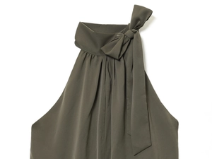 Detail of dark olive halter top featuring shoulder bow tie and pleated neck satin fabric