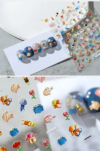 Macro shot of 5D embossed ocean theme nail stickers featuring beach elements