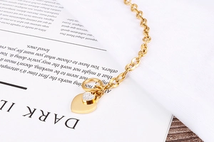 Detail of gold heart pendant bracelet with pavé rhinestones and OT toggle clasp closure