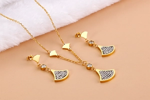Detail of gold fan-shaped necklace and earrings set with sparkling crystal pavé