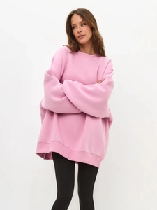 Detail of pink oversized crewneck sweatshirt with smooth knit texture and relaxed fit