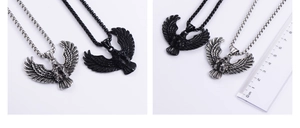 Detail view of eagle wing pendants in vintage silver and matte black with measurement ruler