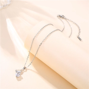 Macro shot of silver butterfly necklace with sparkling zircon stone on a beige display