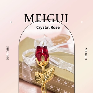 Detailed close-up of a red crystal rose with golden stem inside a heart-shaped gift box