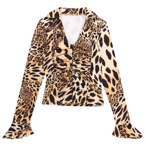 Detail of leopard print blouse with deep V-neckline and decorative ruffle sleeves