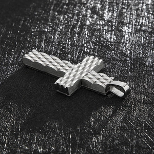Close-up of silver punk style stainless steel cross pendant with woven diamond texture