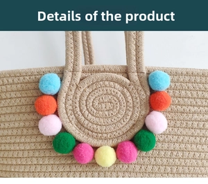 Detailed view of beige handmade woven tote bag with colorful bohemian pompom decorations