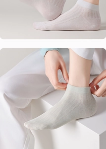 Detailed mesh texture of breathable silk crew socks in white and light green shades