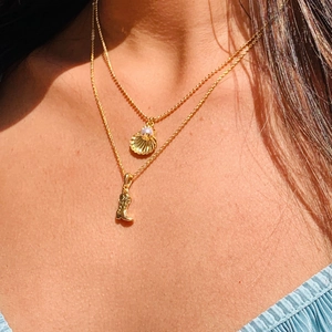 Layered gold necklaces with western boot and shell pearl pendants in 18k gold plating