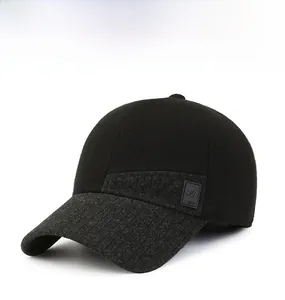 Detail of winter baseball cap showing wool blend fabric and stitched logo patch