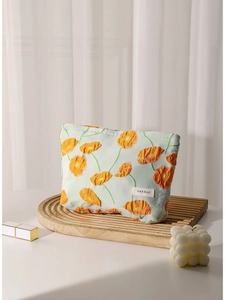 Floral canvas makeup bag with orange flowers on light blue textured fabric base