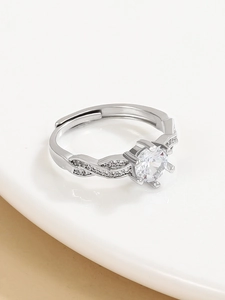 Close-up of a silver adjustable crown ring with twisted band and sparkling cubic zirconia
