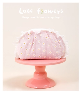 Detail of sweet pink daisy storage bag with delicate white lace trim and drawstring closure