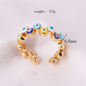 Detail view of gold Evil Eye ring showing 3.5g weight and 6.5mm width dimensions