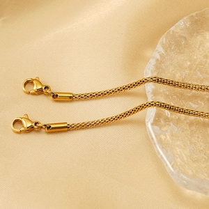 Detailed macro view of 18K gold plated stainless steel popcorn chains with lobster clasps