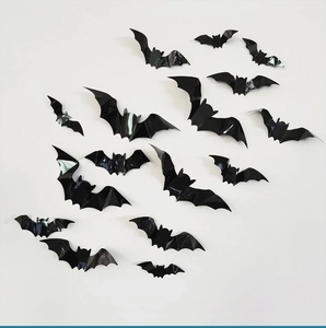 3D black bat wall stickers in various sizes flying across a white background