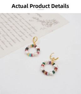Detail of gold hoop earrings with colorful mineral beads and natural irregular pearls