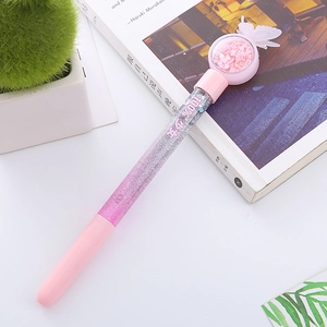 Pink glitter liquid sand neutral pen with butterfly topper and gradient sequins on desk