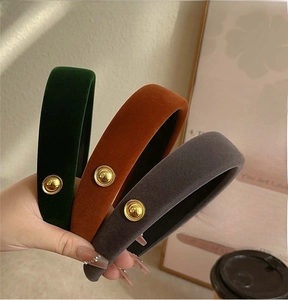Detail of vintage velvet padded headbands with elegant golden button and non-slip lining