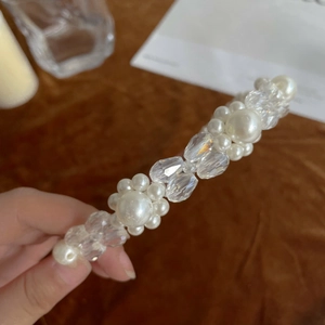 Macro shot of faux pearls and faceted clear beads on a minimalist headband detail