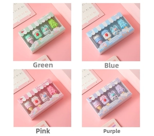 Close-up of cute cartoon rabbit and ice cream shaped erasers in colorful window gift boxes