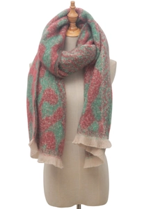 Close-up of red and green leopard jacquard scarf with soft beige tassel fringe details