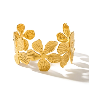 Gold plated stainless steel hollow flower bangle with 3D embossed petal design on white background